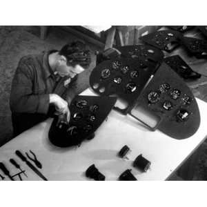 Technician Busy Fitting Various Instruments on a Control Panel in the 
