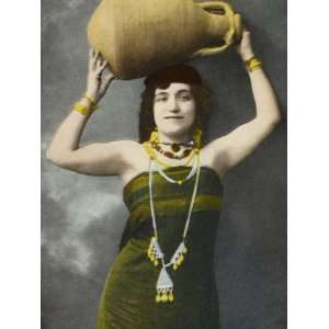  An Egyptian Woman Holding Aloft a Large Pottery Jar 