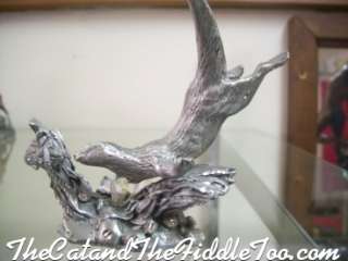 This is a sculpture of a of a Sea Otter chasing fishes 