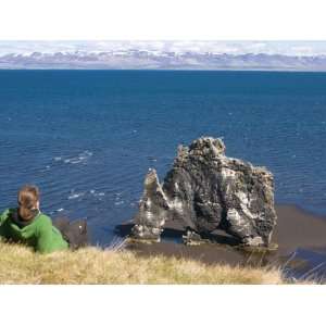  Tourist Relaxing at Famous Hvitserkur Rock Formation 