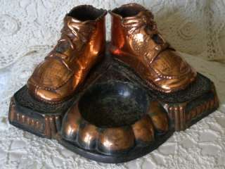 ANTIQUE PAIR BRONZED BABY SHOES ON ORNATE PLATEFORM  