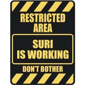   RESTRICTED AREA SURI IS WORKING  PARKING SIGN