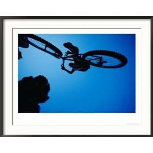  A Mountain Biker Careens in the Air and the Photographer 