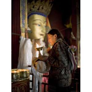  Woman Adding Yak Butter from Her Butter Lamp to Those in 